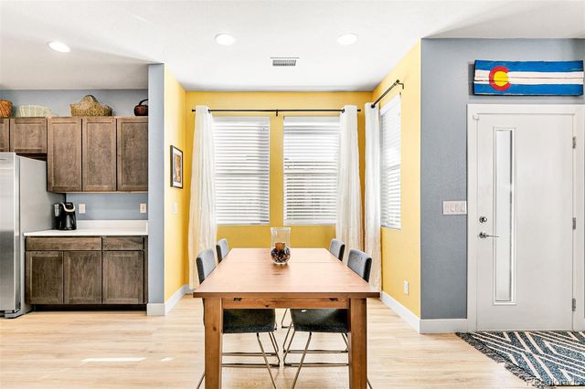 a view of a kitchen with a table and chairs