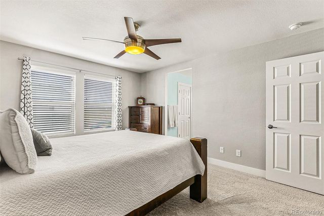 a bedroom with a bed dresser and a window