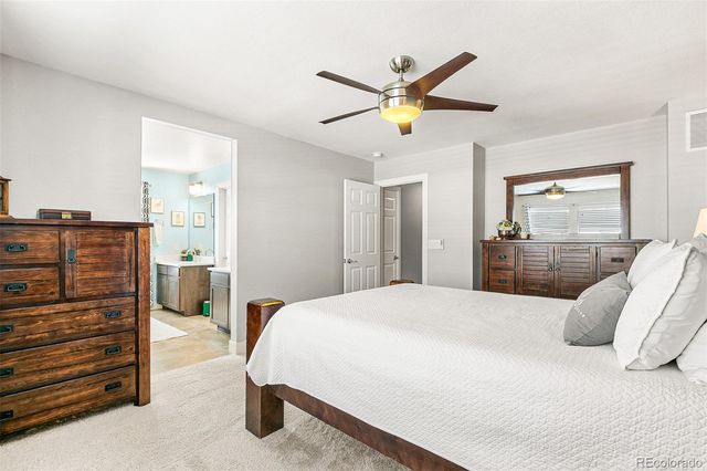 a bedroom with a bed and ceiling fan