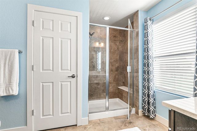 a bathroom with a glass shower door
