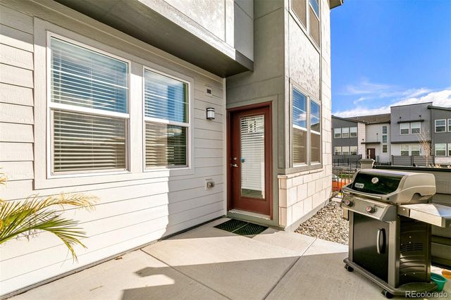 a view of a patio with table and chairs and potted plants