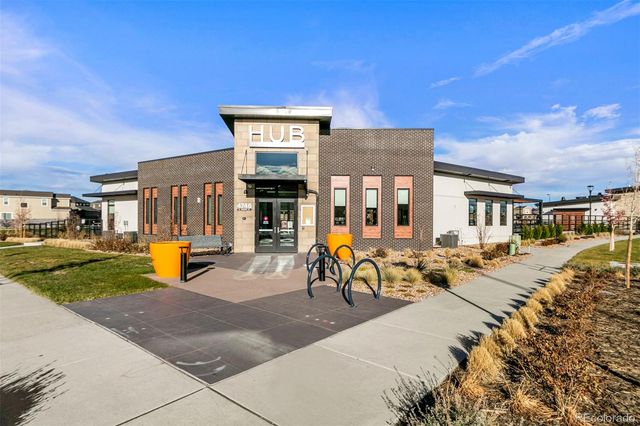 a view of a swimming pool with a lounge chairs in front of house