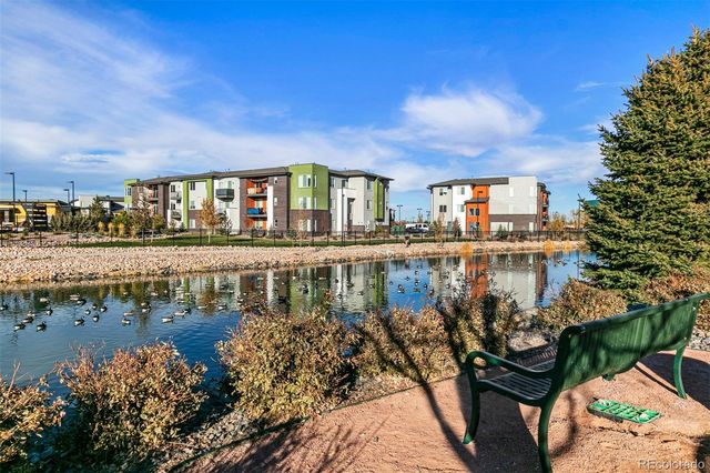 a view of a lake with a house in the background