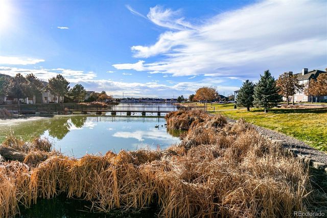 a view of a lake with houses in the background