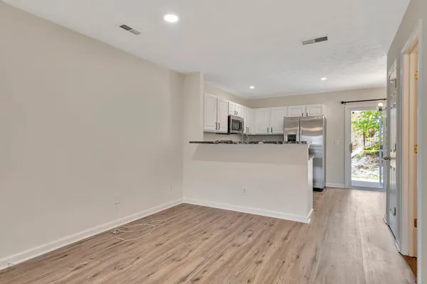 a view of a kitchen with wooden floor