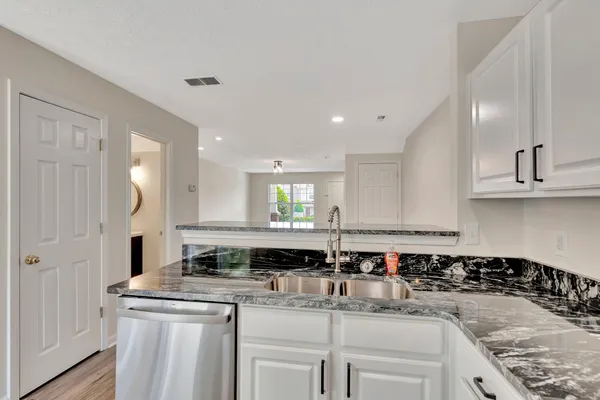 a kitchen with a sink stove and cabinets