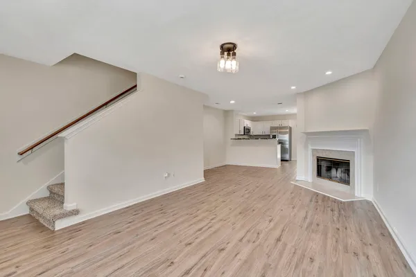 a view of kitchen and hallway with wooden floor