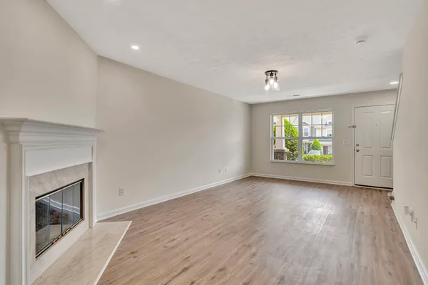 an empty room with windows and a fireplace