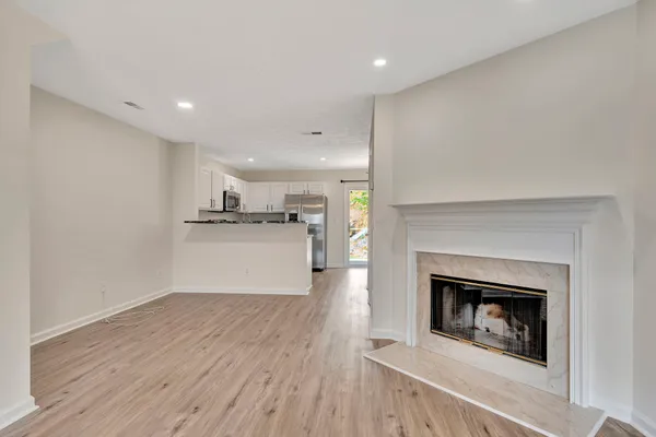 a view of a kitchen with a fireplace wooden floor and a window