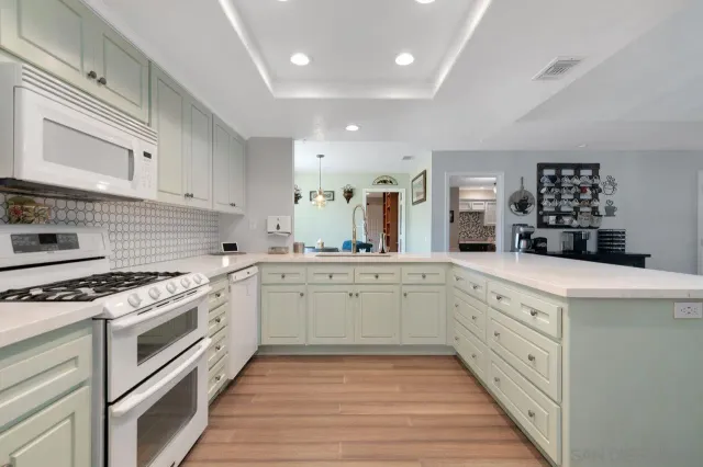 a kitchen with granite countertop cabinets stainless steel appliances and a counter space