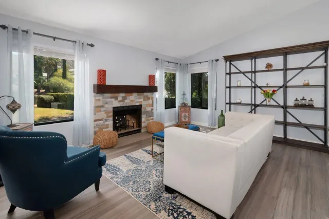 a living room with furniture and a fireplace