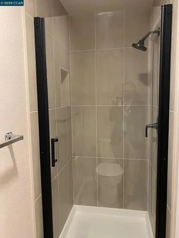 a bathroom with a shower and a sink