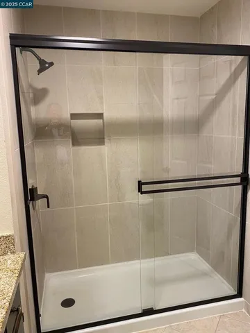 a bathroom with a glass shower door
