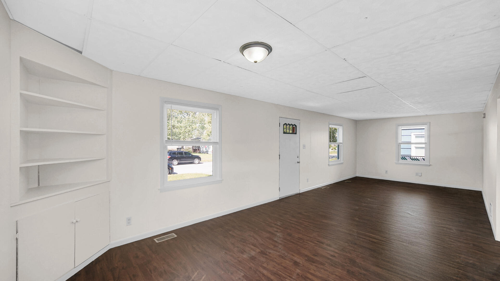 6723 Baring Avenue Hammond, IN 46324 - Photo 5 of 23 a view of an empty room with a window and wooden floor