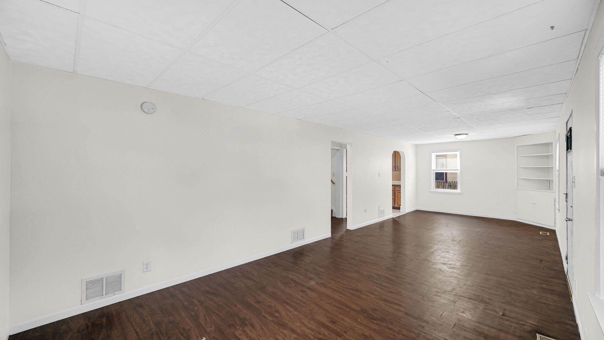 6723 Baring Avenue Hammond, IN 46324 - Photo 6 of 23 an empty room with wooden floor and windows