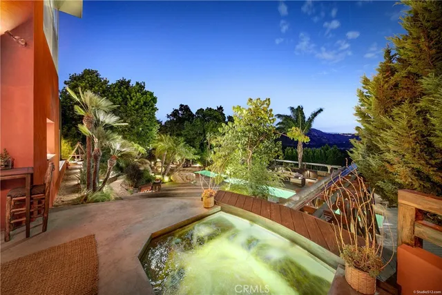 swimming pool view with a garden