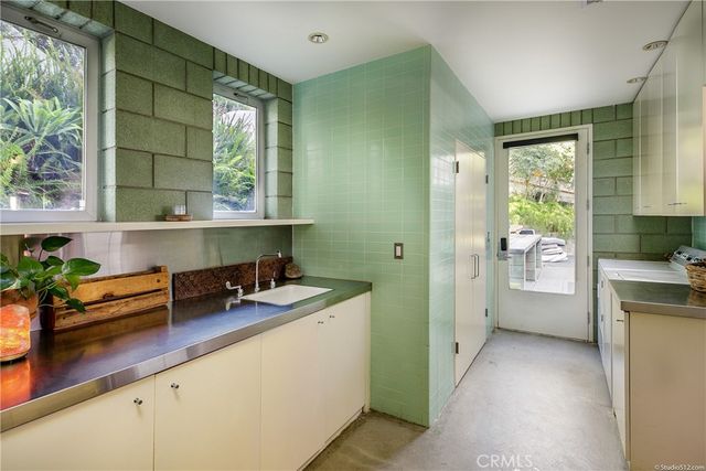 a bathroom with a sink a mirror and a window