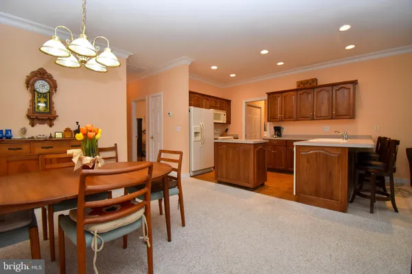 a view of a dining room with furniture and chandelier