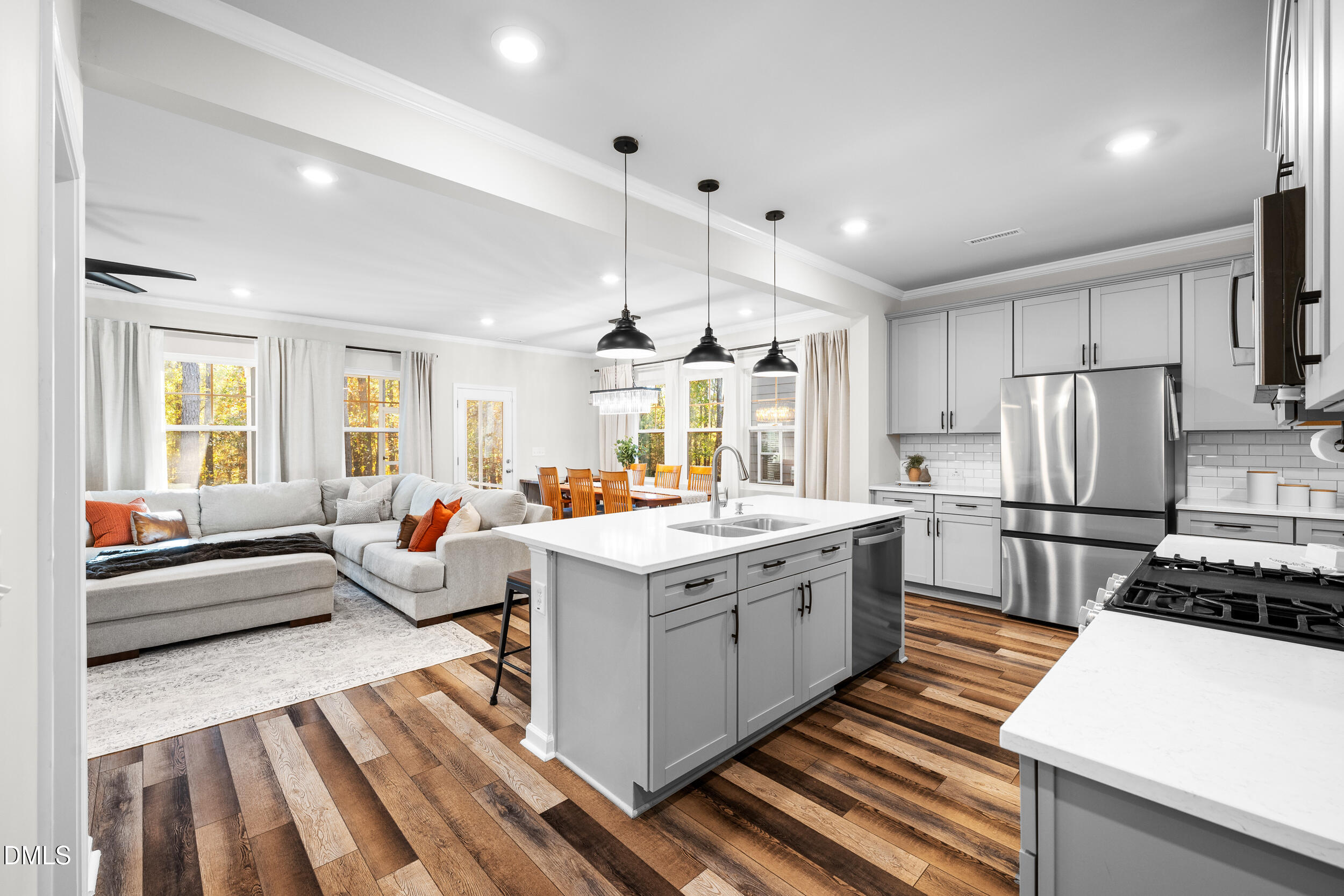 a open kitchen with stainless steel appliances granite countertop a stove and a refrigerator