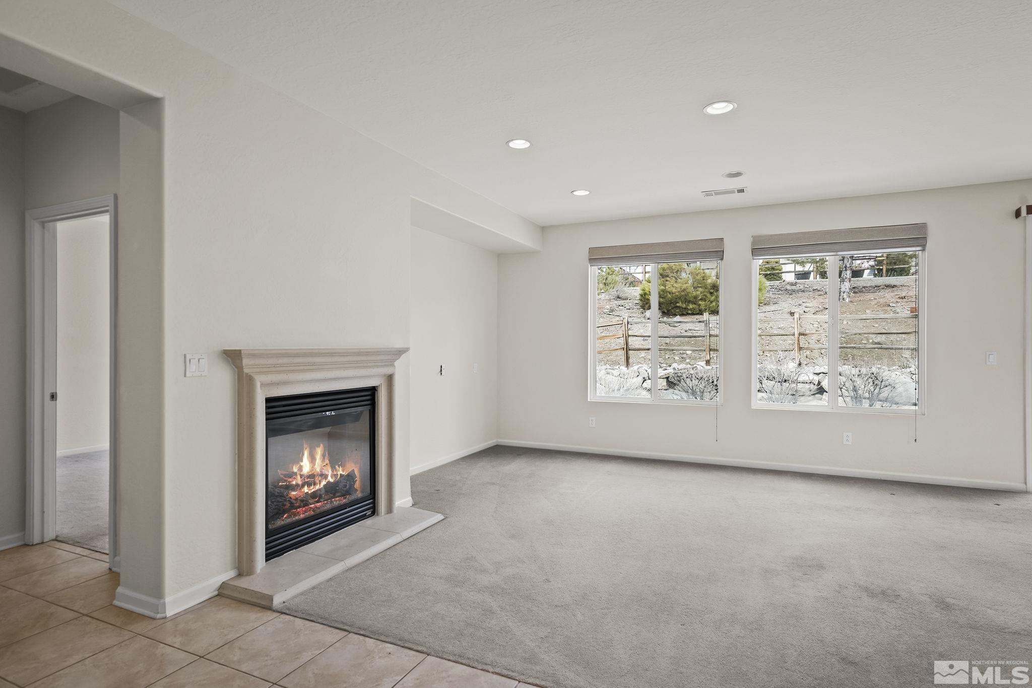 9185 Heritage Ridge Court Reno, NV 89523 - Photo 4 of 31 a view of an empty room with a fireplace and a window