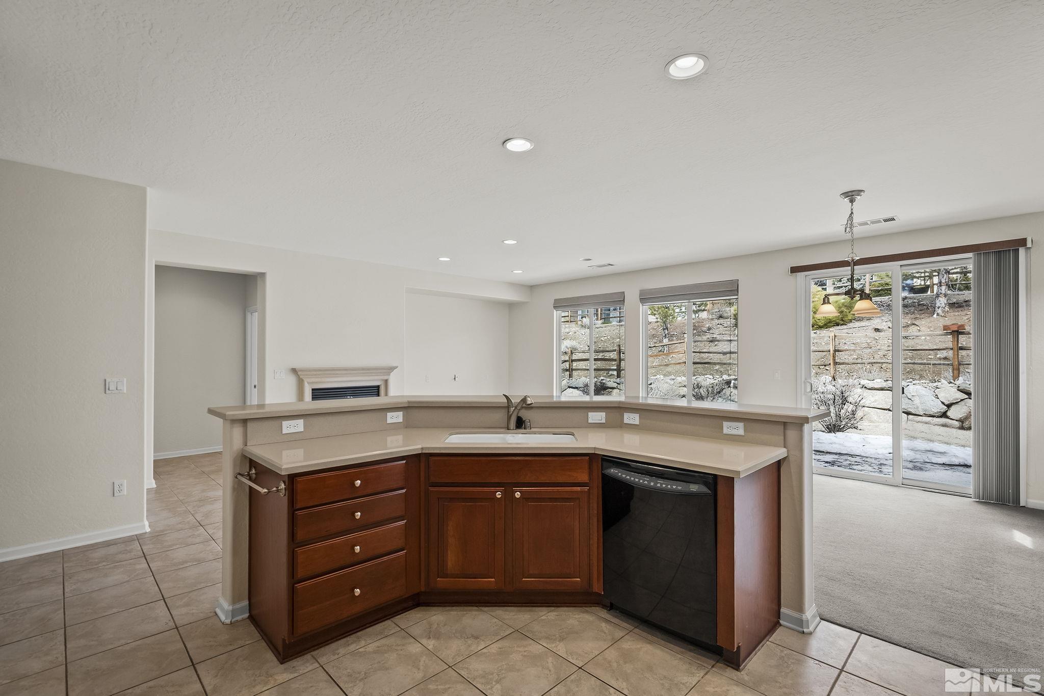 9185 Heritage Ridge Court Reno, NV 89523 - Photo 10 of 31 a kitchen with a stove a sink and a refrigerator