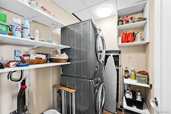 a utility room with stainless steel appliances a refrigerator and a window