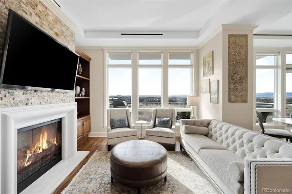 a living room with a fireplace a flat screen tv and a fireplace