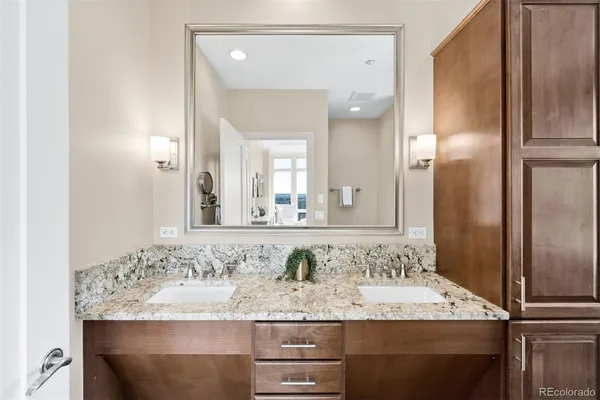 a bathroom with a granite countertop sink and a mirror