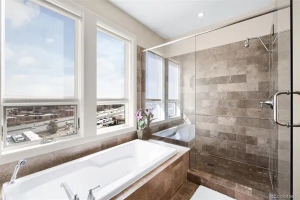 a living room with a large window and walk in closet