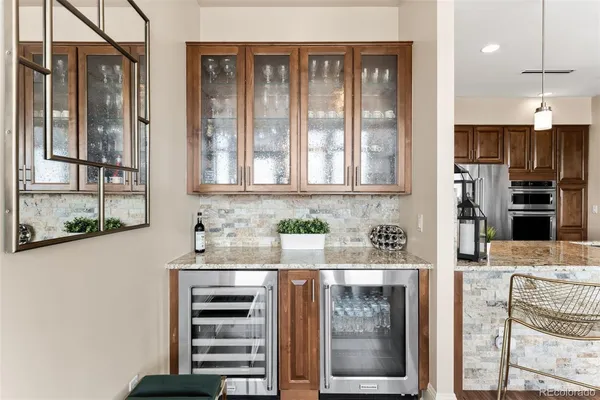 a kitchen with stainless steel appliances granite countertop a refrigerator and a stove