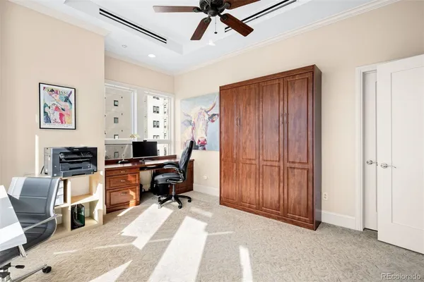 a view of a workspace with furniture and windows