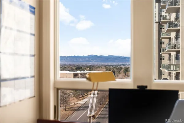 a view of a lake from a balcony with outdoor seating