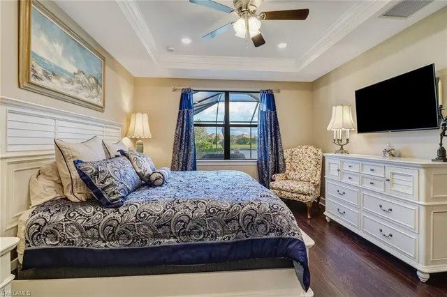 a bedroom with a large bed and a flat screen tv