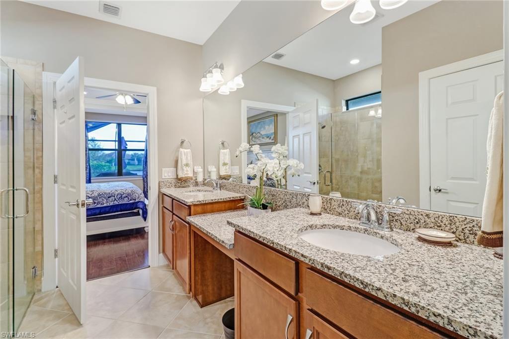7567 Winding Cypress Drive Naples, FL 34114 - Photo 12 of 24 a en suite bathroom with a granite countertop double vanity
