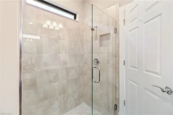 a bathroom with a glass shower door