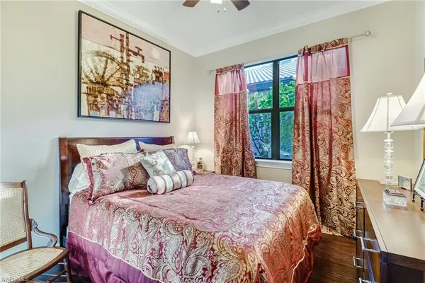 a bedroom with a bed and a painting on the wall