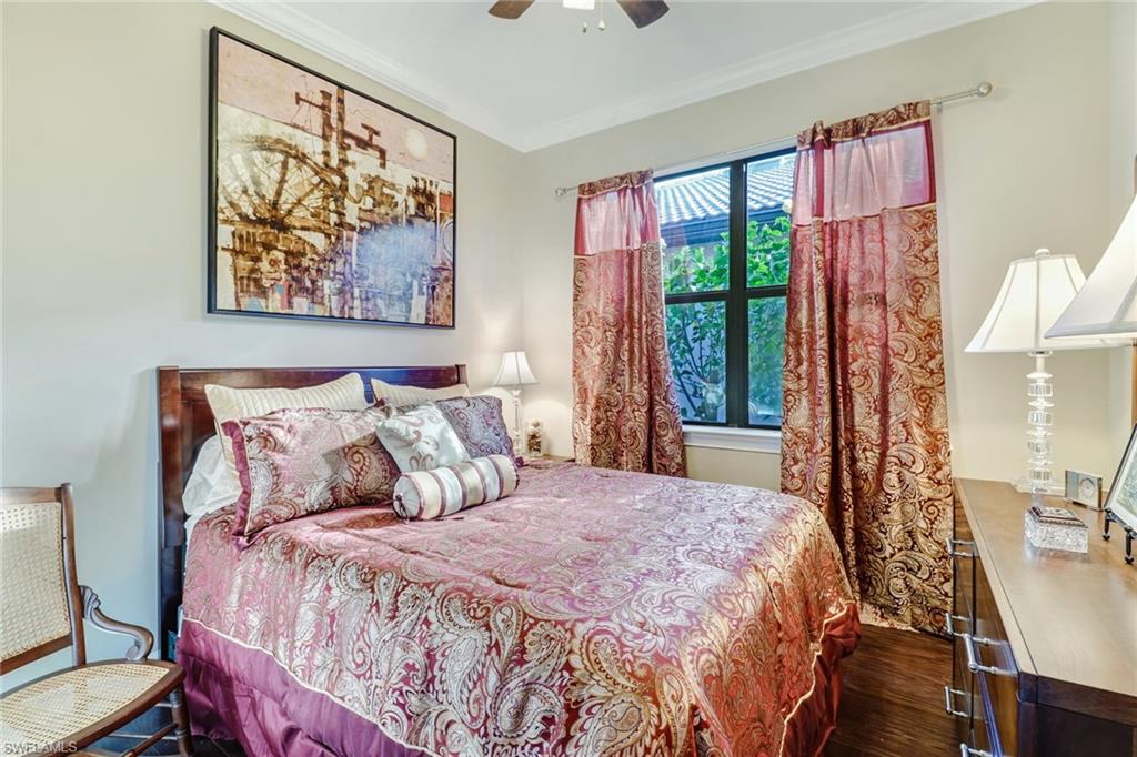 7567 Winding Cypress Drive Naples, FL 34114 - Photo 14 of 24 a bedroom with a bed and a painting on the wall