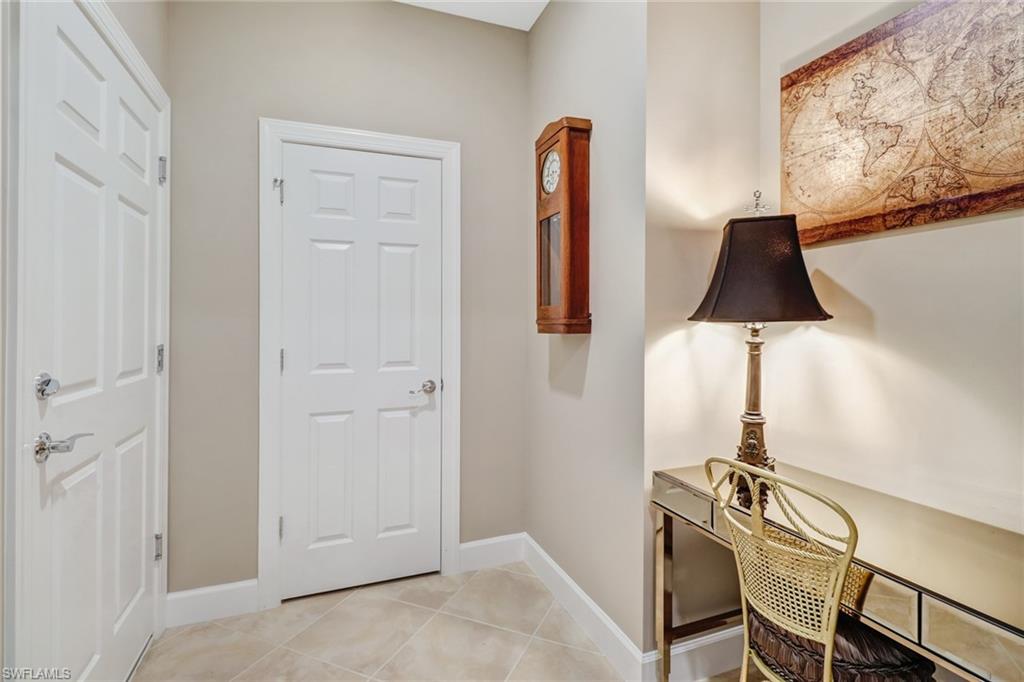 7567 Winding Cypress Drive Naples, FL 34114 - Photo 17 of 24 a room with a table and a chair