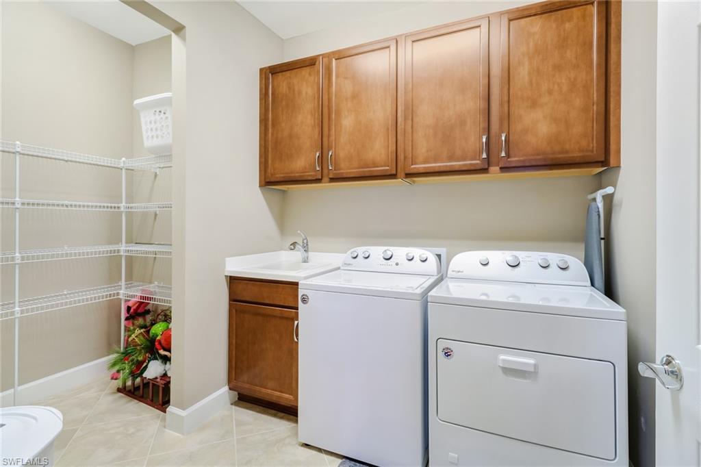 7567 Winding Cypress Drive Naples, FL 34114 - Photo 18 of 24 a utility room with dryer and washer