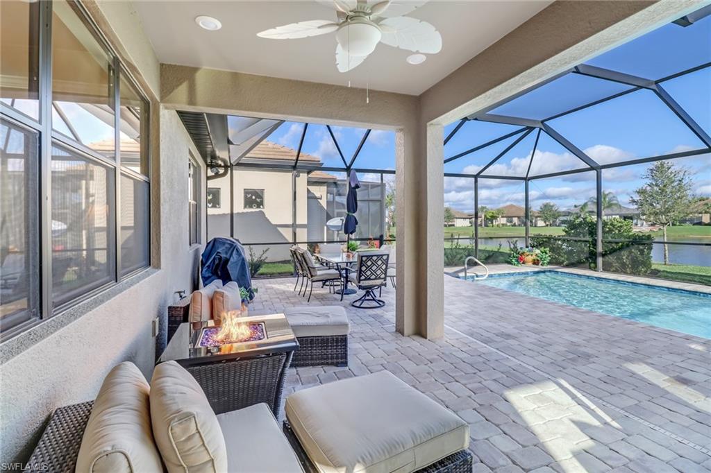 7567 Winding Cypress Drive Naples, FL 34114 - Photo 19 of 24 a dining room with furniture and a floor to ceiling window