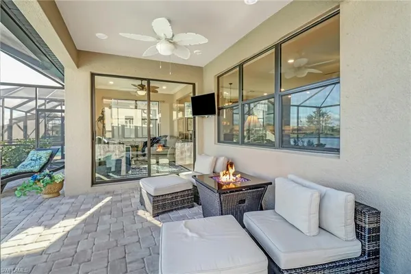 a living room with furniture and a floor to ceiling window