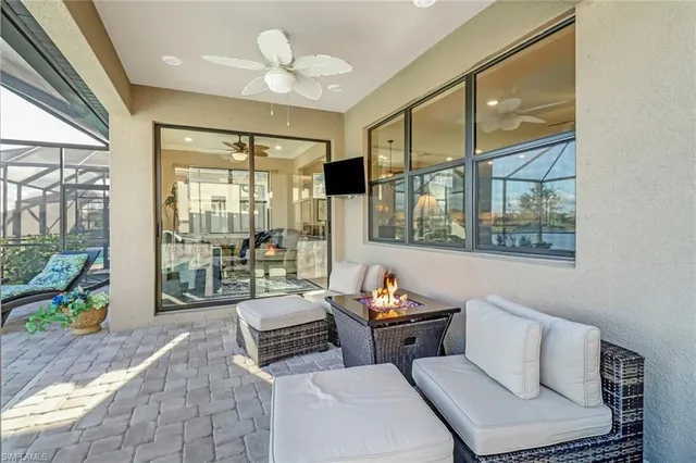 a living room with furniture and a floor to ceiling window
