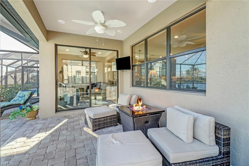 7567 Winding Cypress Drive Naples, FL 34114 - Photo 20 of 24 a living room with furniture and a floor to ceiling window