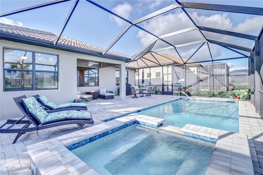 7567 Winding Cypress Drive Naples, FL 34114 - Photo 2 of 24 a view of a patio with a table and chairs