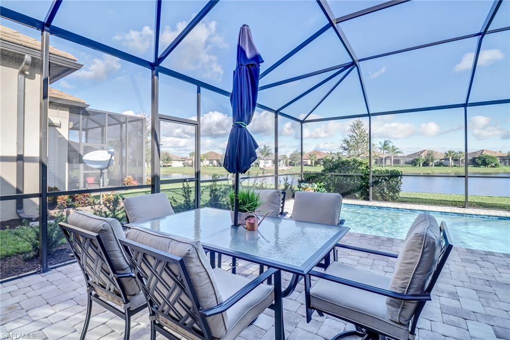 7567 Winding Cypress Drive Naples, FL 34114 - Photo 21 of 24 a view of an outdoor dining space with furniture and table