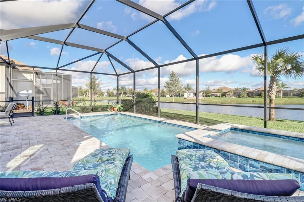 7567 Winding Cypress Drive Naples, FL 34114 - Photo 23 of 24 a view of a swimming pool with a lounge chair
