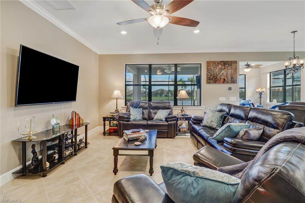 7567 Winding Cypress Drive Naples, FL 34114 - Photo 4 of 24 a living room with furniture and a flat screen tv