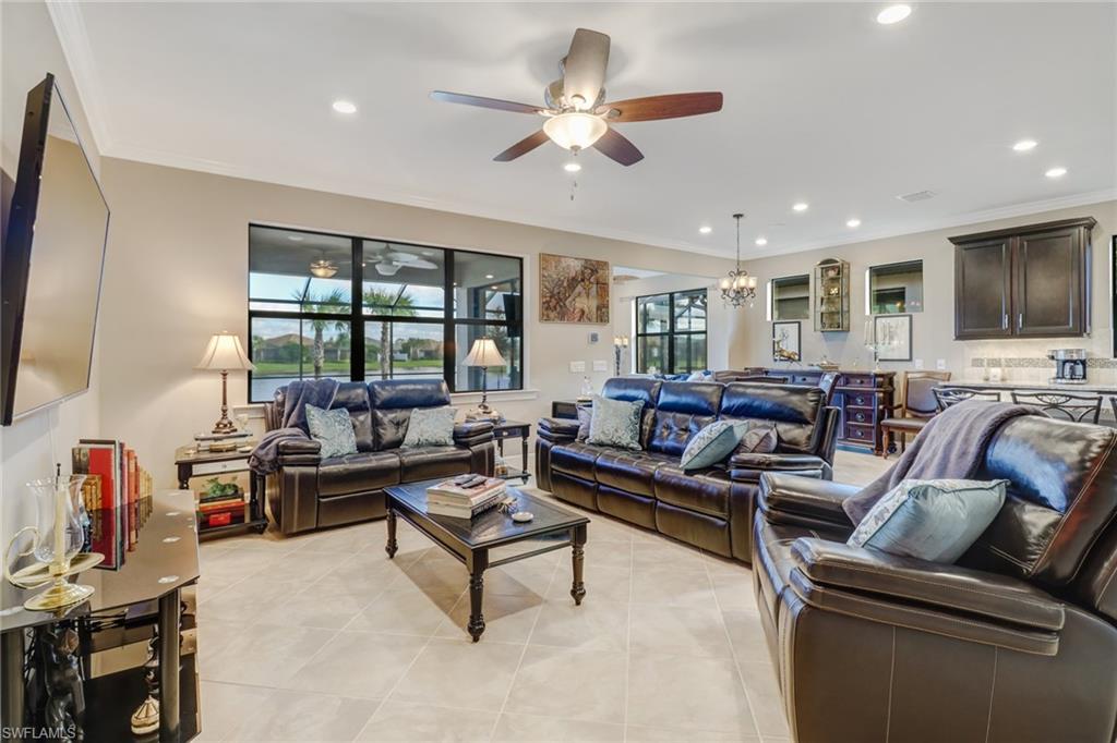 7567 Winding Cypress Drive Naples, FL 34114 - Photo 5 of 24 a living room with furniture ceiling fan and a flat screen tv