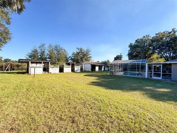 a view of house with swimming pool outdoor seating