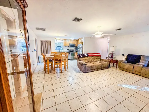 a living room with furniture and a chandelier